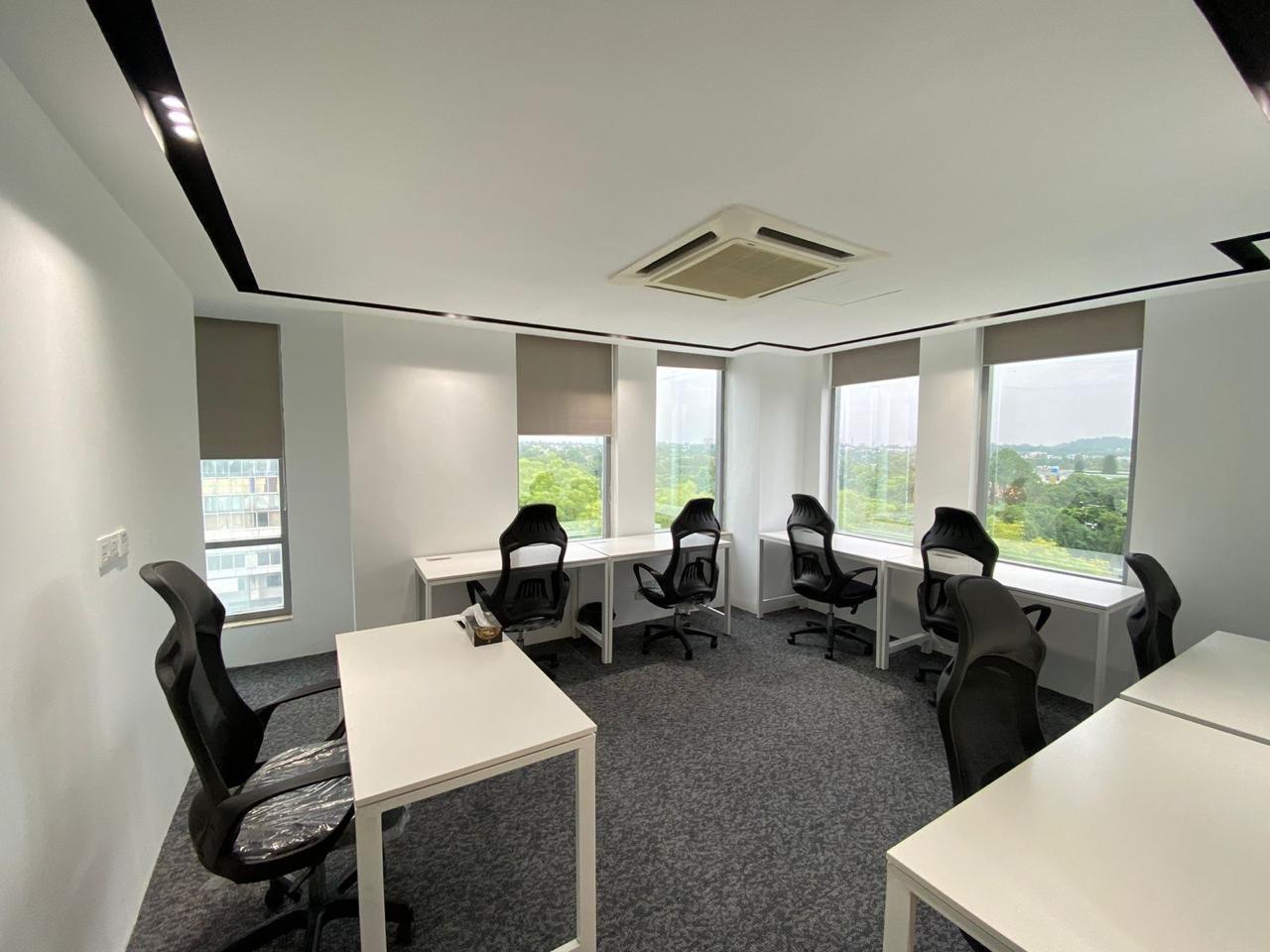 Modern shared office workspace in Islamabad with desks, ergonomic chairs, and large windows